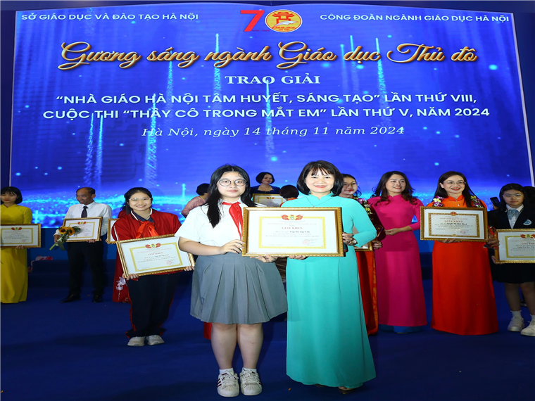 A group of people holding certificatesDescription automatically generated