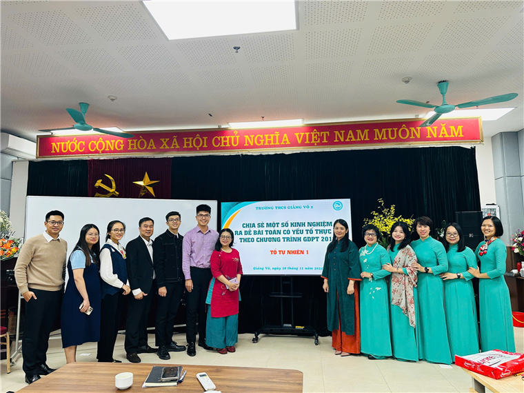 A group of people standing in front of a white boardDescription automatically generated