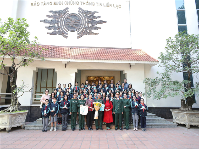 A group of people in uniform standing in front of a buildingDescription automatically generated