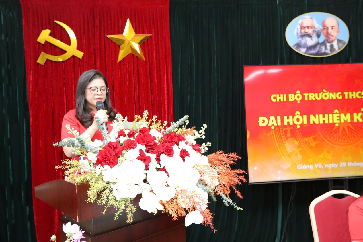 A person speaking into a microphoneDescription automatically generated