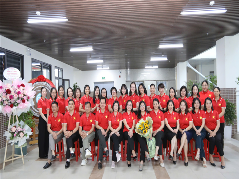 A group of people in red shirtsDescription automatically generated