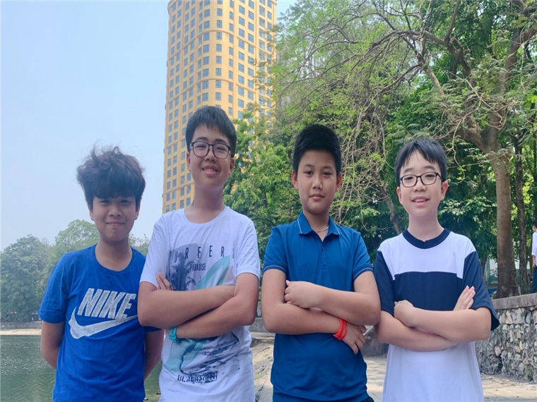 A group of boys standing together with arms crossedDescription automatically generated