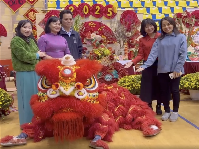 A group of people posing with a lion garmentAI-generated content may be incorrect.