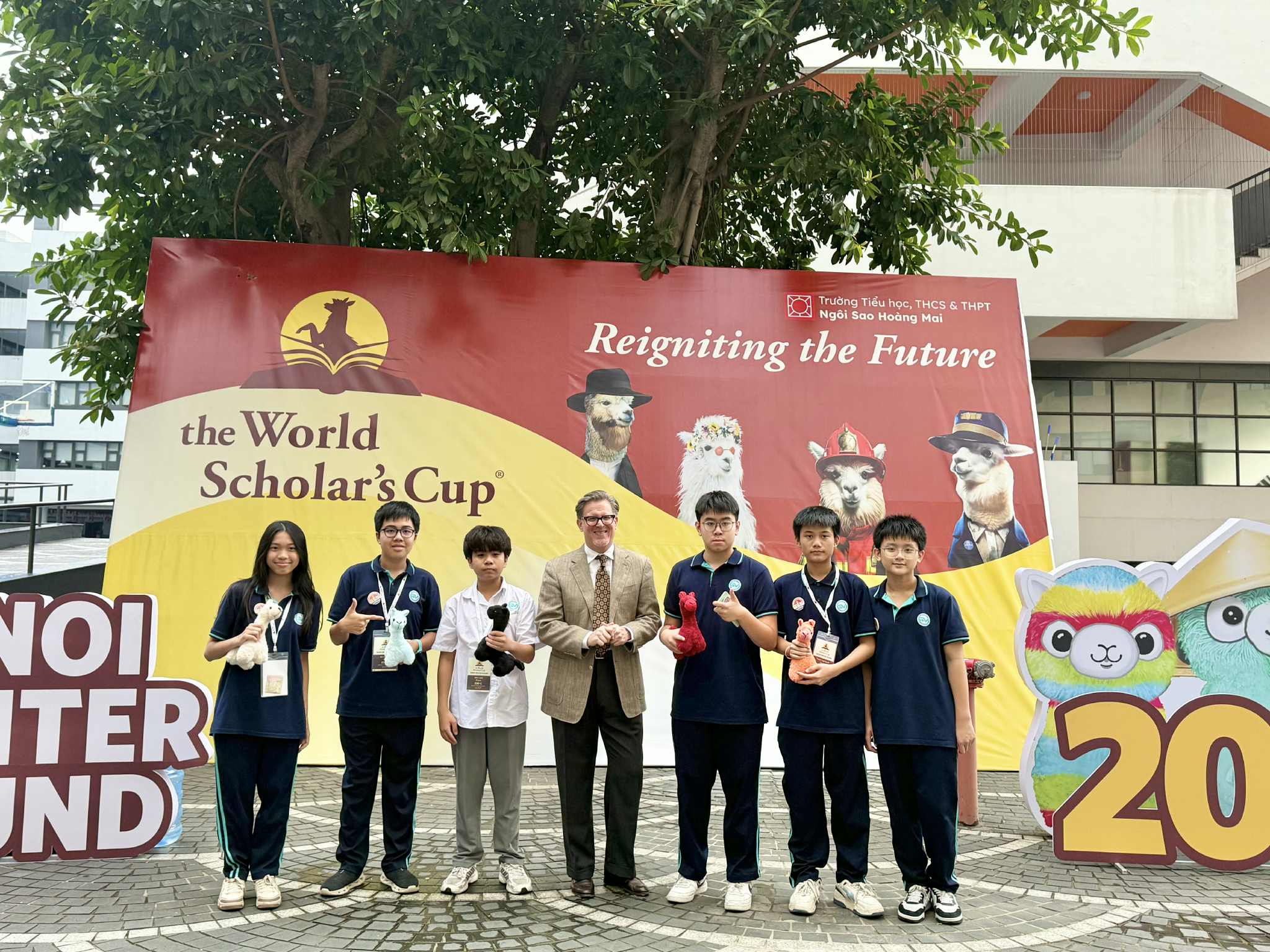 A group of people standing in front of a bannerAI-generated content may be incorrect.