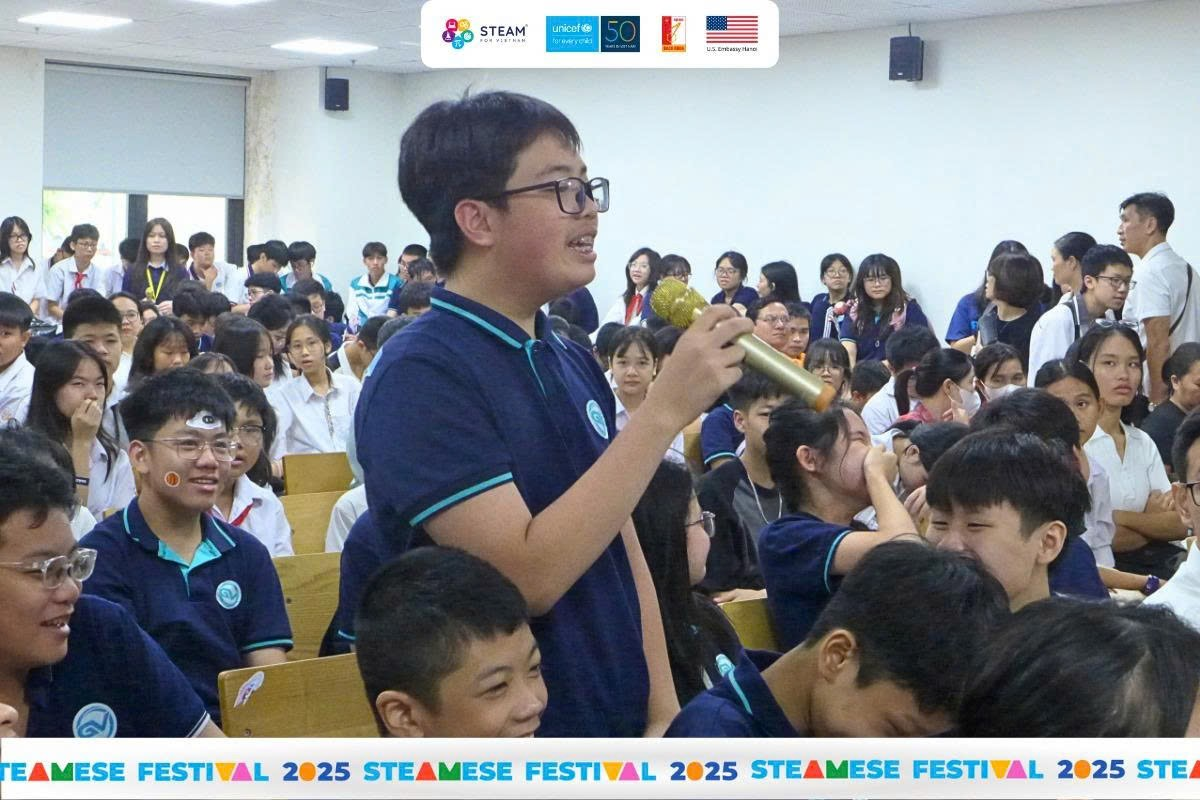 A person holding a microphone in front of a group of peopleAI-generated content may be incorrect.