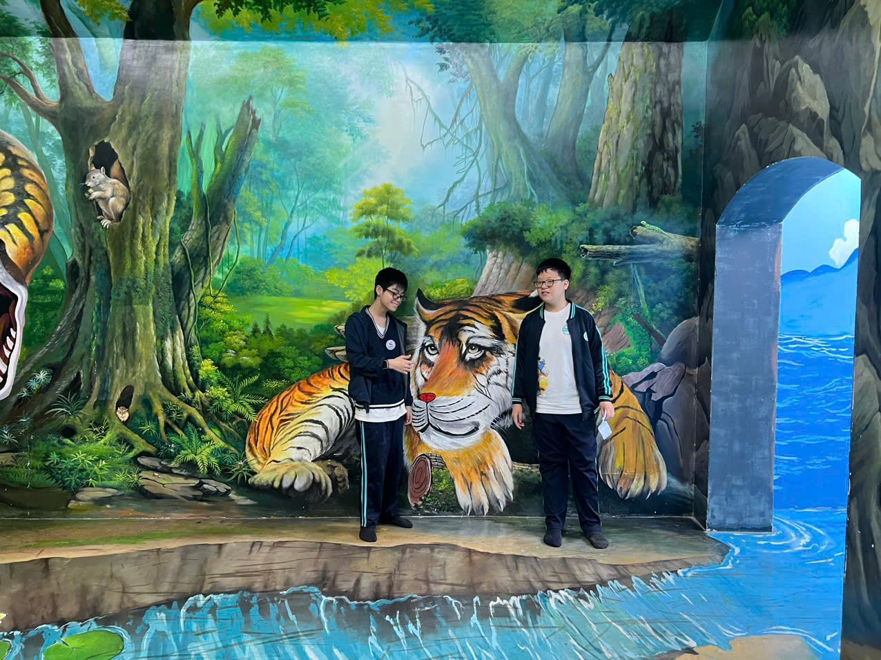 Two men standing in front of a muralAI-generated content may be incorrect.