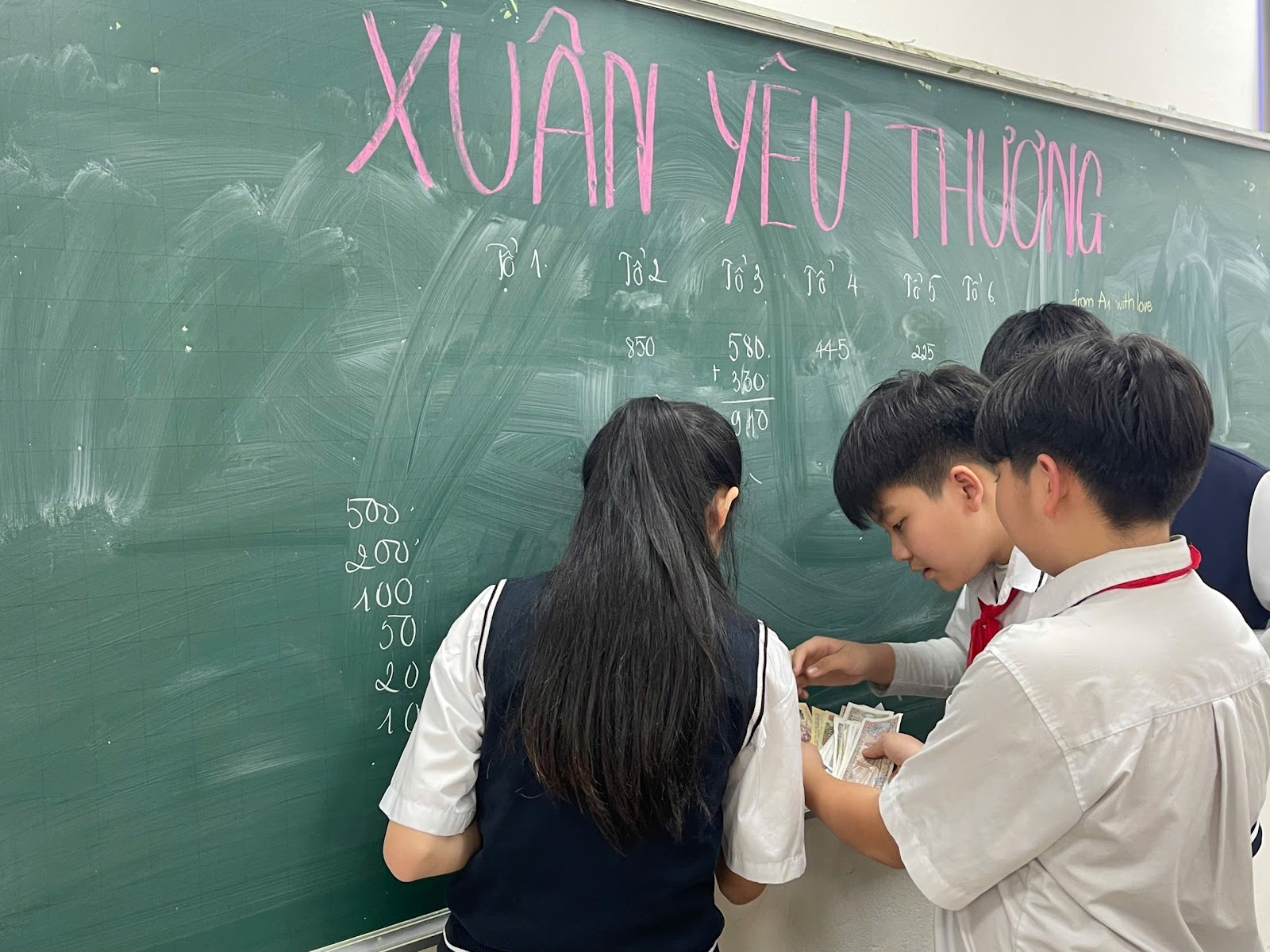 A group of people standing in front of a chalkboardAI-generated content may be incorrect.