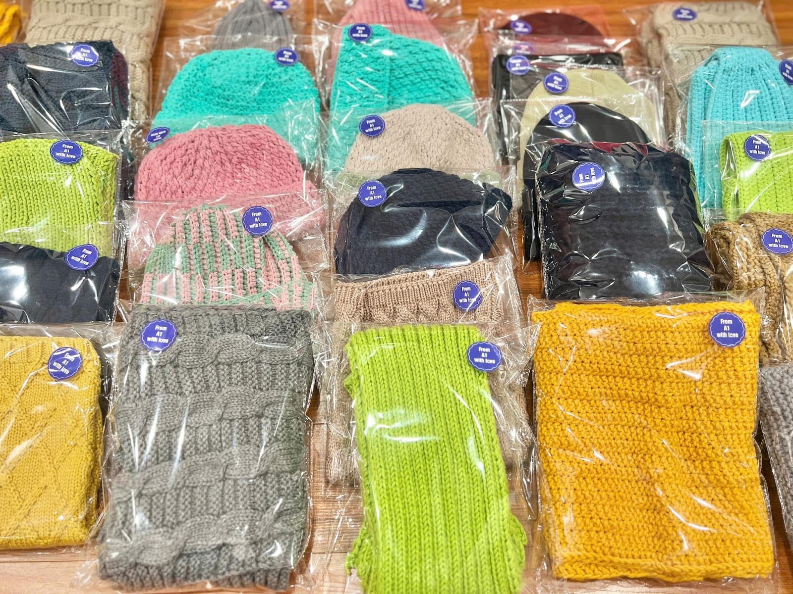 A group of colorful hats in plastic bagsAI-generated content may be incorrect.