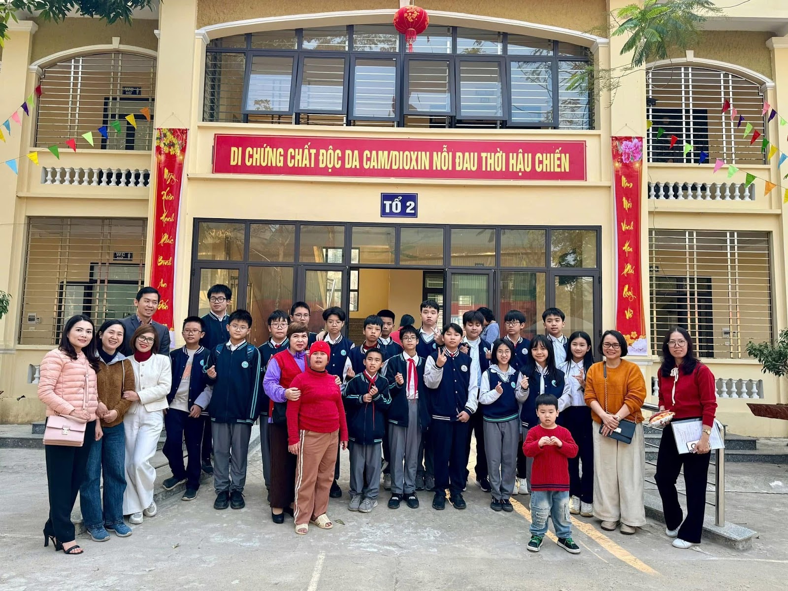 A group of people standing in front of a buildingAI-generated content may be incorrect.