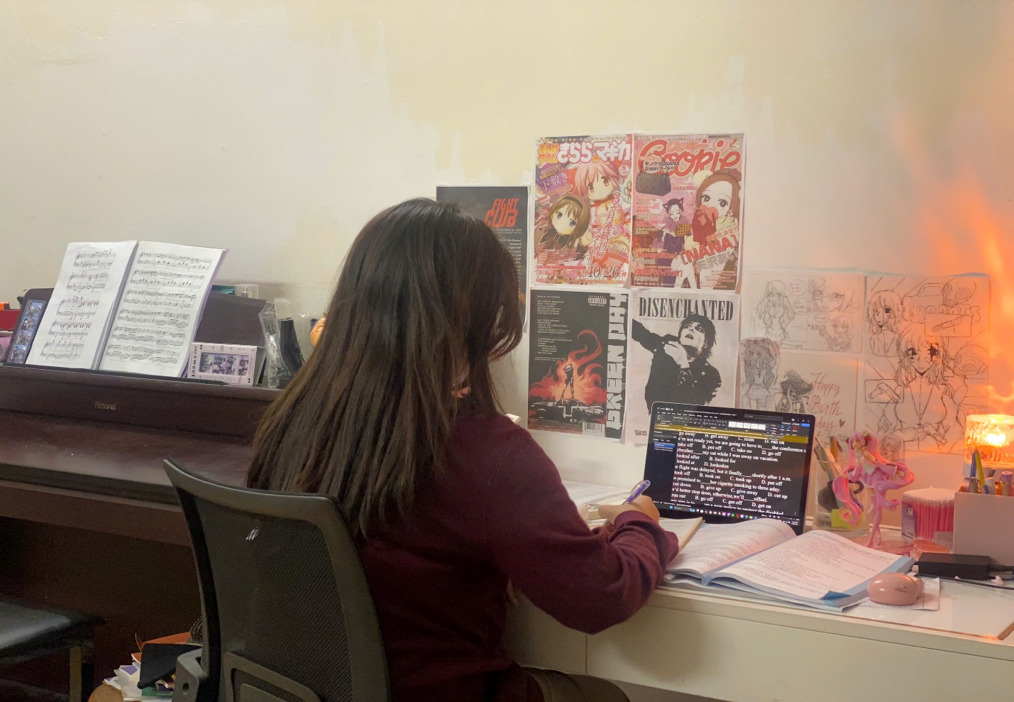 A person sitting at a desk writing on a bookAI-generated content may be incorrect.