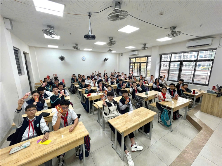 A group of students sitting at desks in a classroomDescription automatically generated