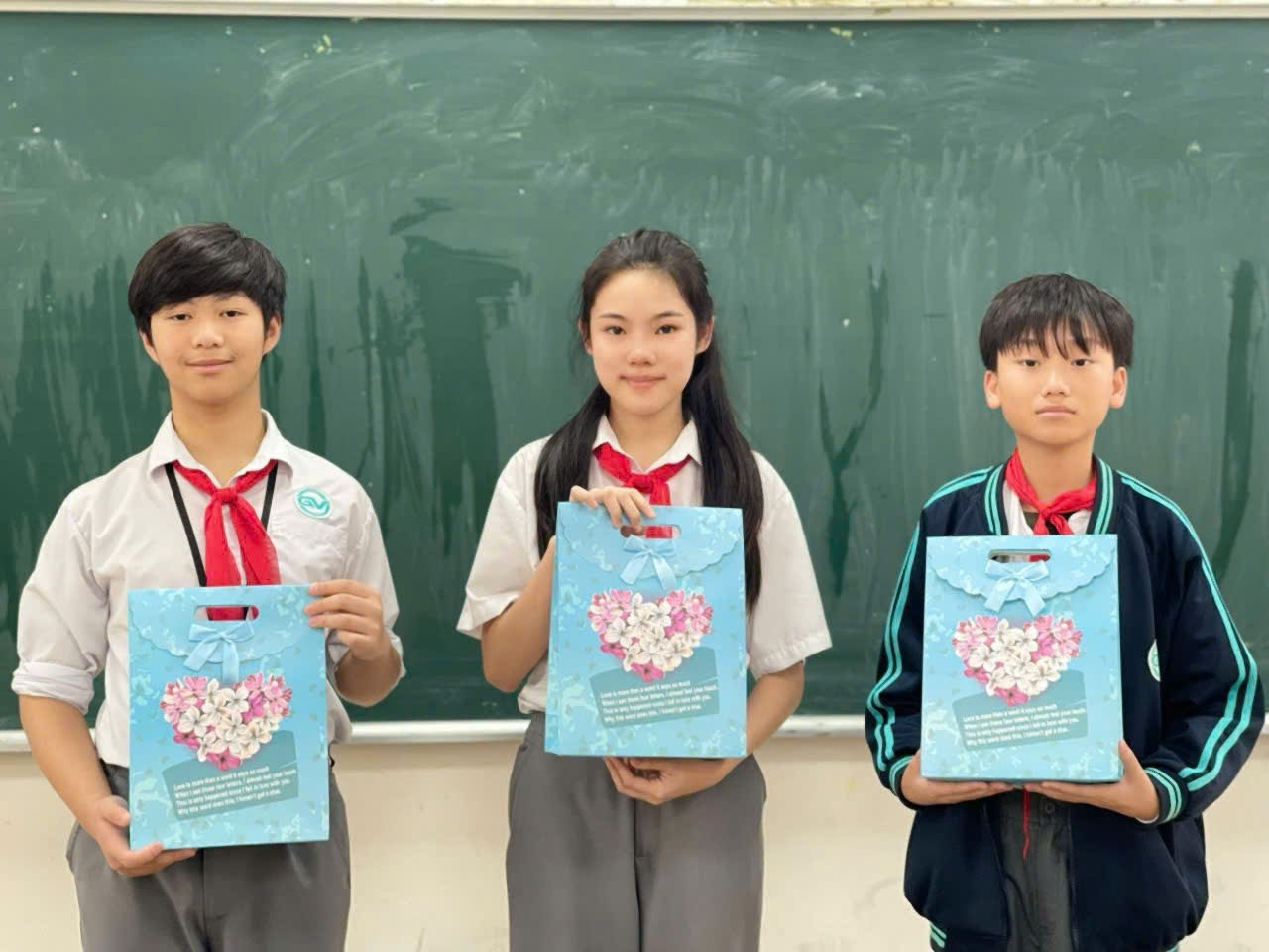 A group of people holding bags in front of a chalkboardAI-generated content may be incorrect.