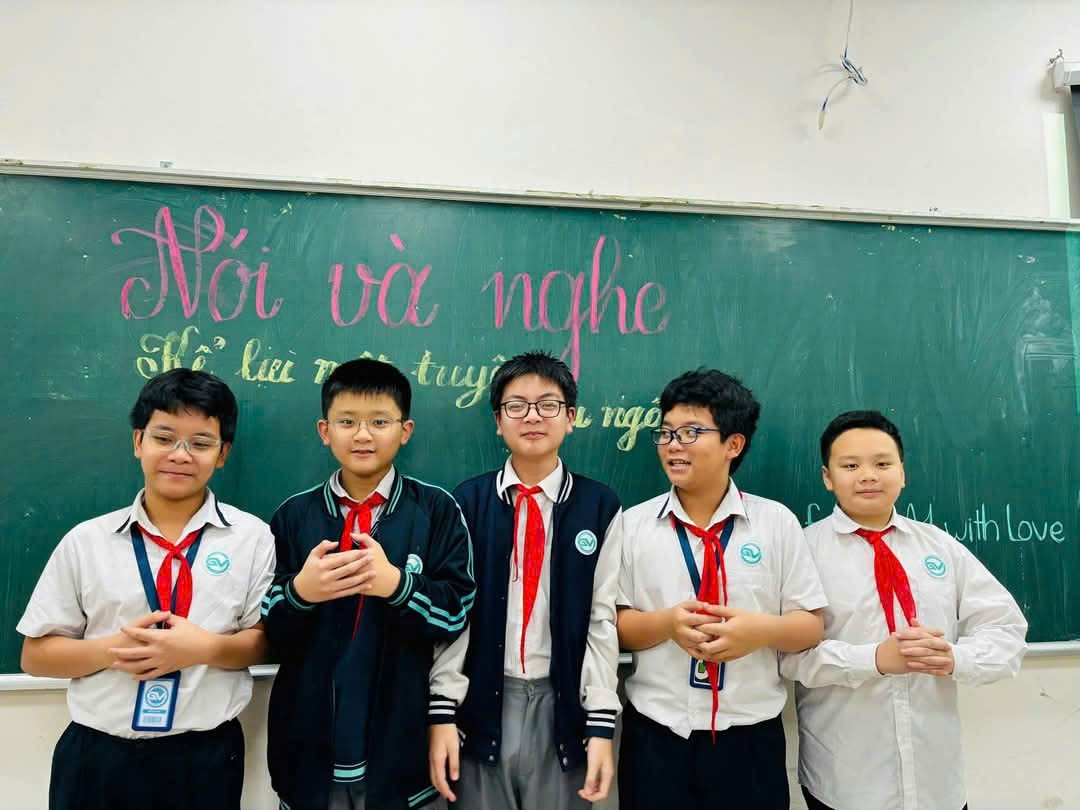 A group of boys in uniform standing in front of a chalkboardAI-generated content may be incorrect.