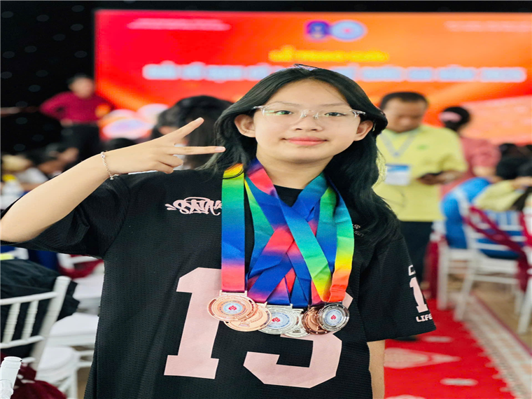 A child with medals around her neckAI-generated content may be incorrect.