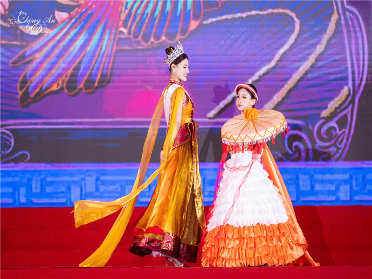 Two women in dresses on a stageAI-generated content may be incorrect.