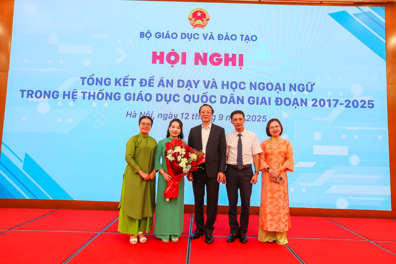 A group of people standing in front of a large screenAI-generated content may be incorrect.