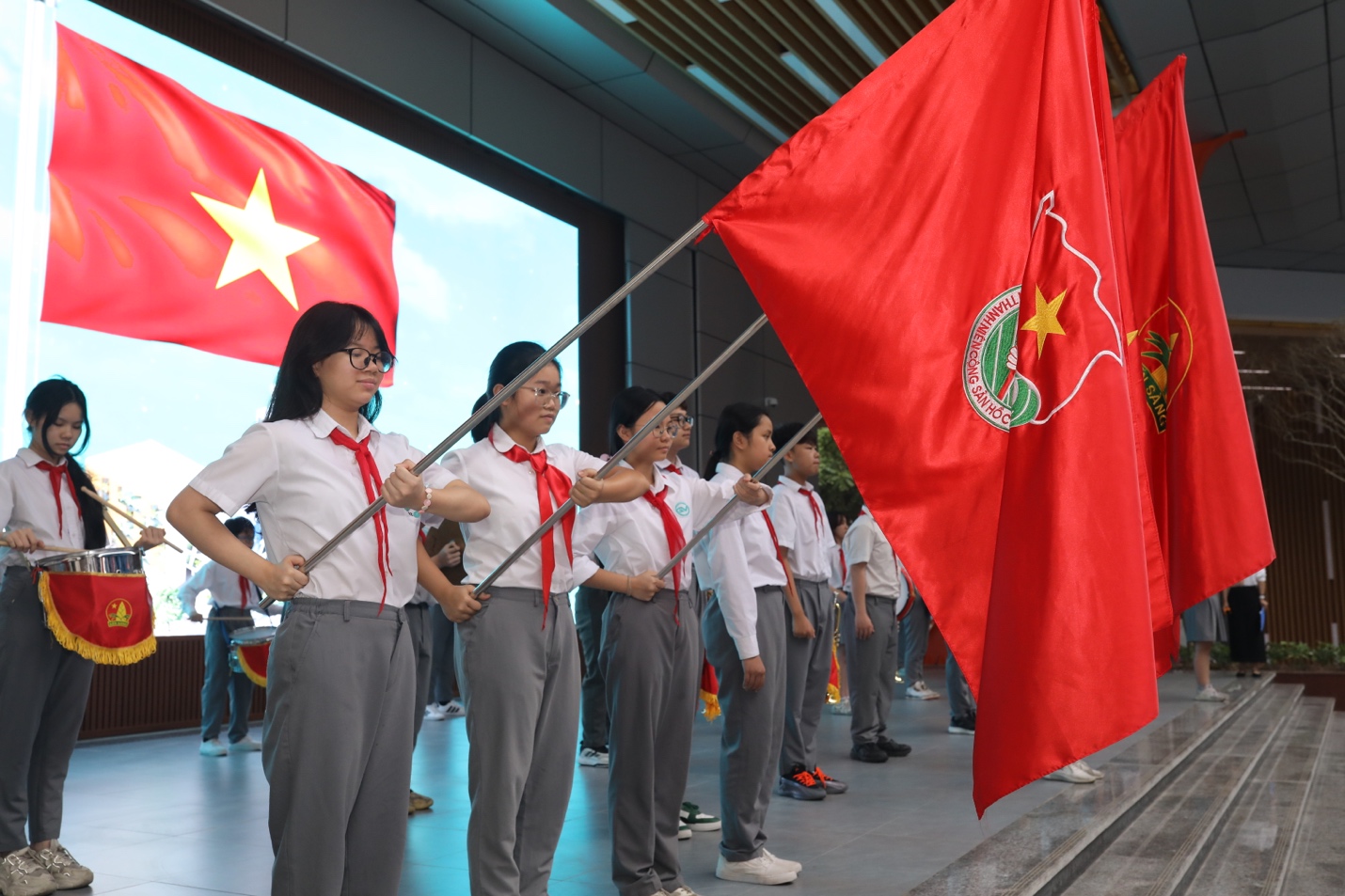 A group of people holding flagsDescription automatically generated