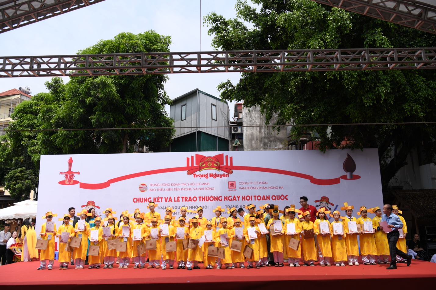 A group of people wearing yellow clothesDescription automatically generated