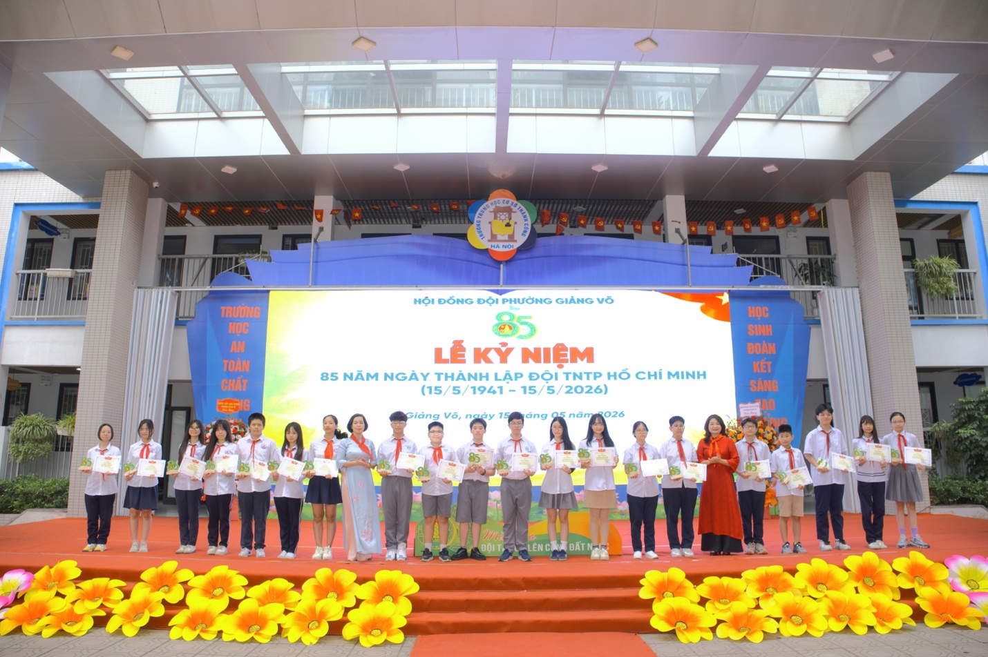 A group of children standing on a stageDescription automatically generated