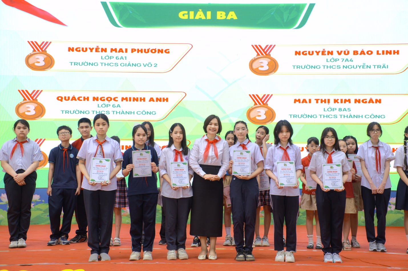 A group of people standing together holding certificatesDescription automatically generated